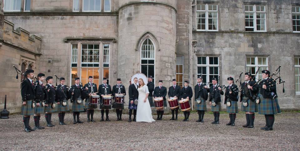 Stockbridge Pipe Band forming a guard of honour for a wedding couple at Melville Castle